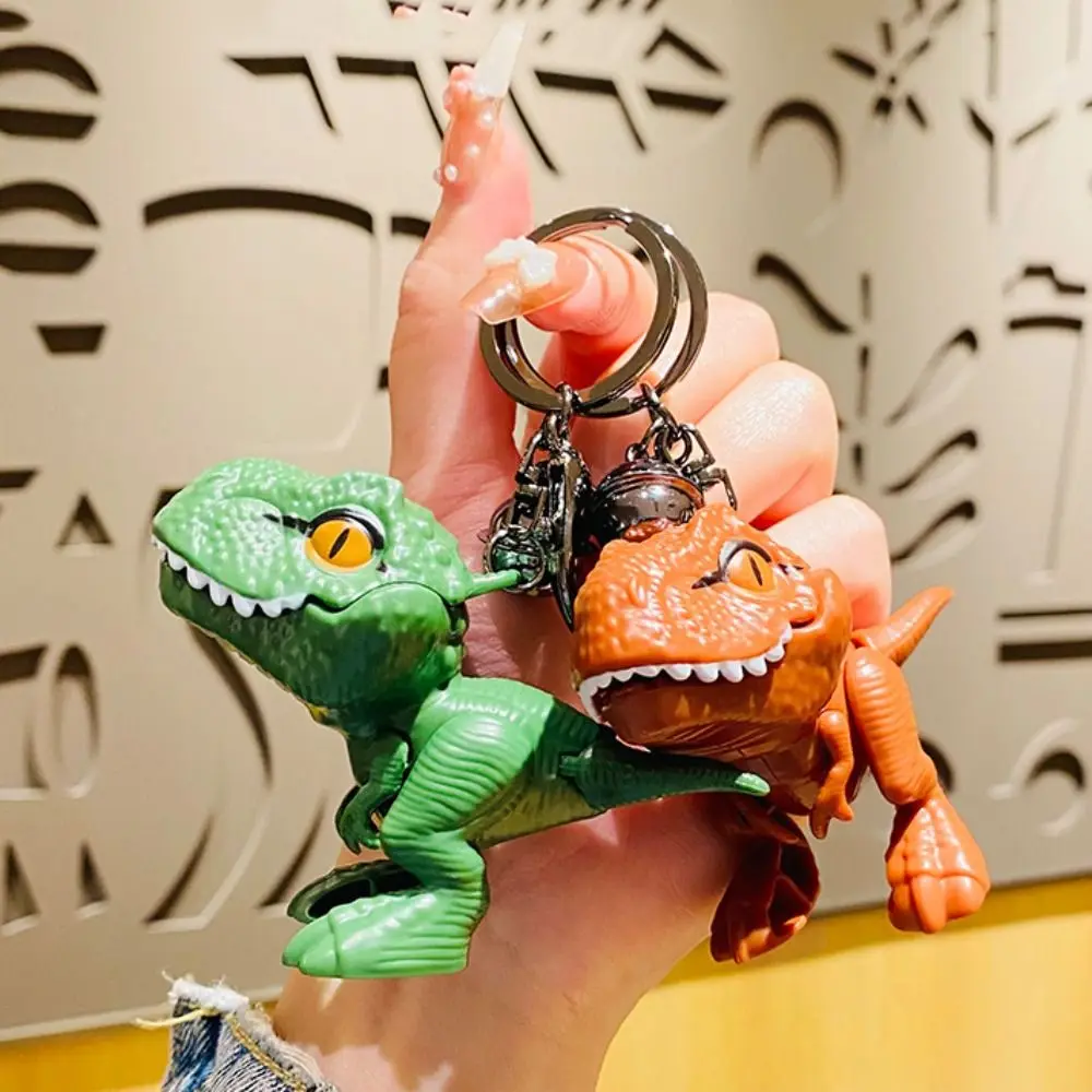 漫画恐竜ティラノサウルスレックス人形キーホルダー手を噛む恐竜の手を噛む恐竜キーリングファッションプラスチック