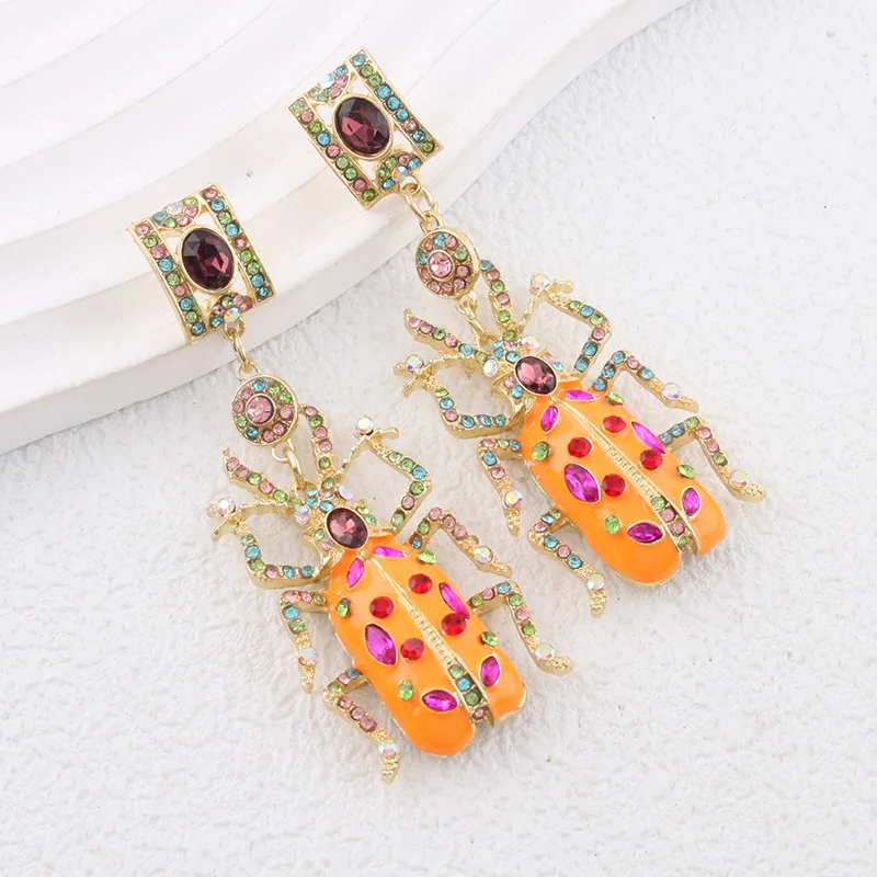 Vintage-style colorful beetle earrings with unique and stylish gemstone embellishments, perfect for travel and vacation jewelry