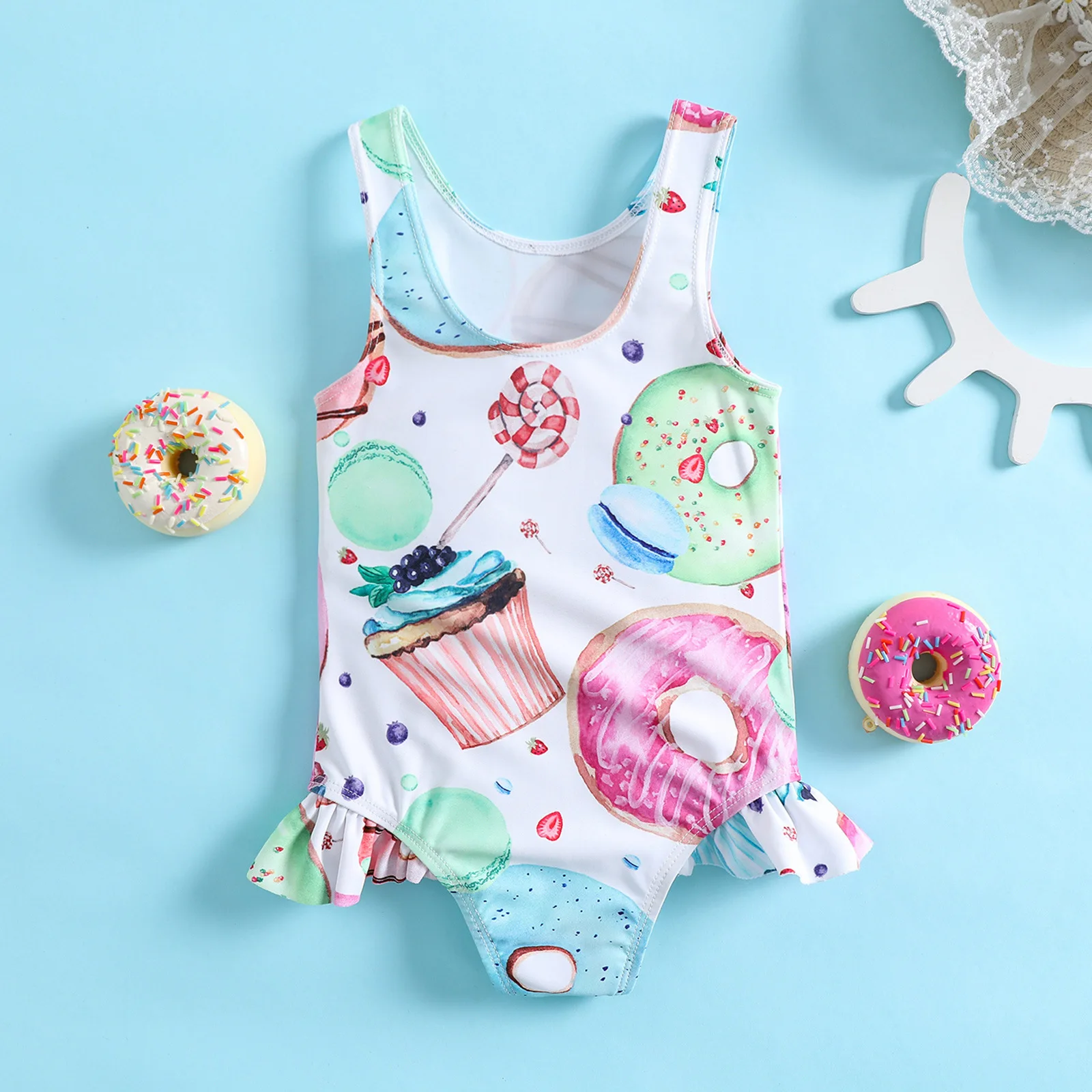 Toddler one piece swimsuit with ruffle and donut cupcake dessert pattern for pool and beach water play