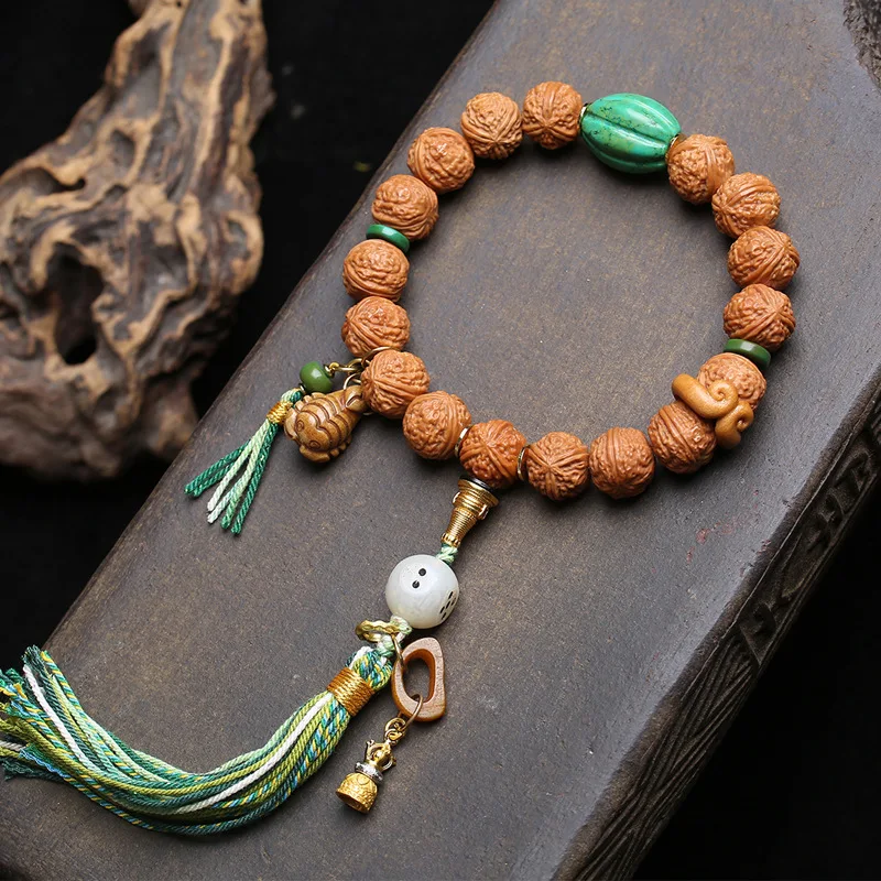 

Single-strandnatural monkey head bodhi bead bracelet with peachwood pearls and recycled bone accessories forhandling and playing