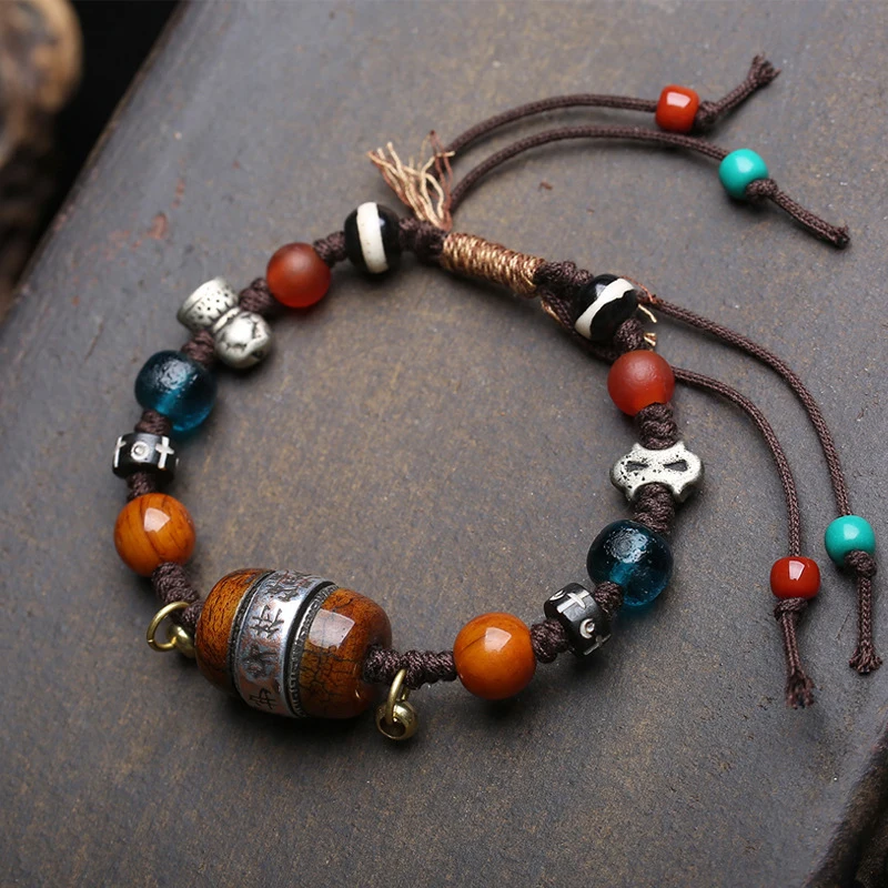 

Handmade woven rope bracelet with inlaid bone silver amulet, beads, agate, and glass accessories