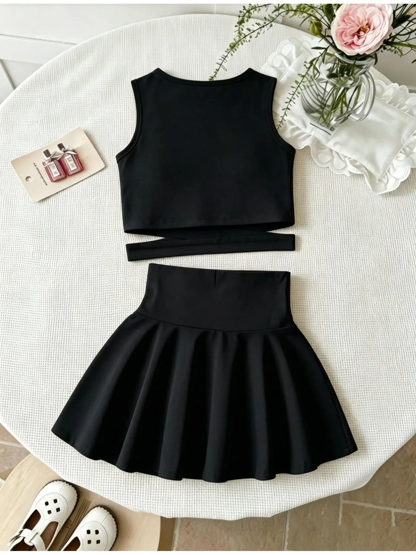 Mädchen-Set aus süßem, schmal geschnittenem, einfarbigem, ärmellosem Crop-Top und hochtailliertem, plissiertem Skaterrock aus weichem Stoff für Tanztraining und Sommerkleidung. – Detail 9