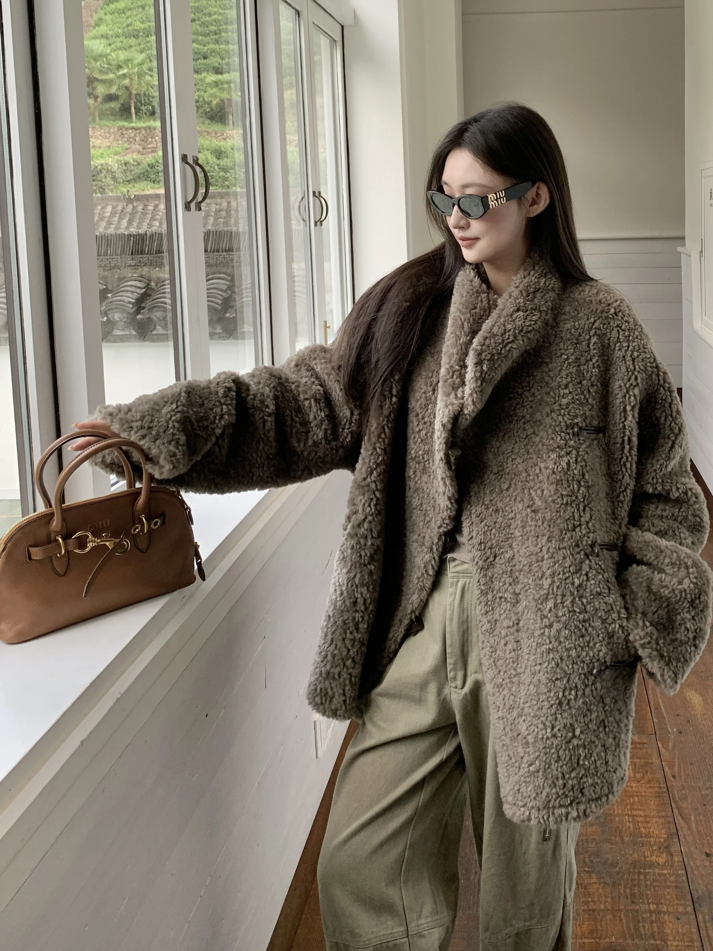 A new double-sided winter faux lambskin and horn-buckle fur long coat, an eco-friendly fur coat for women