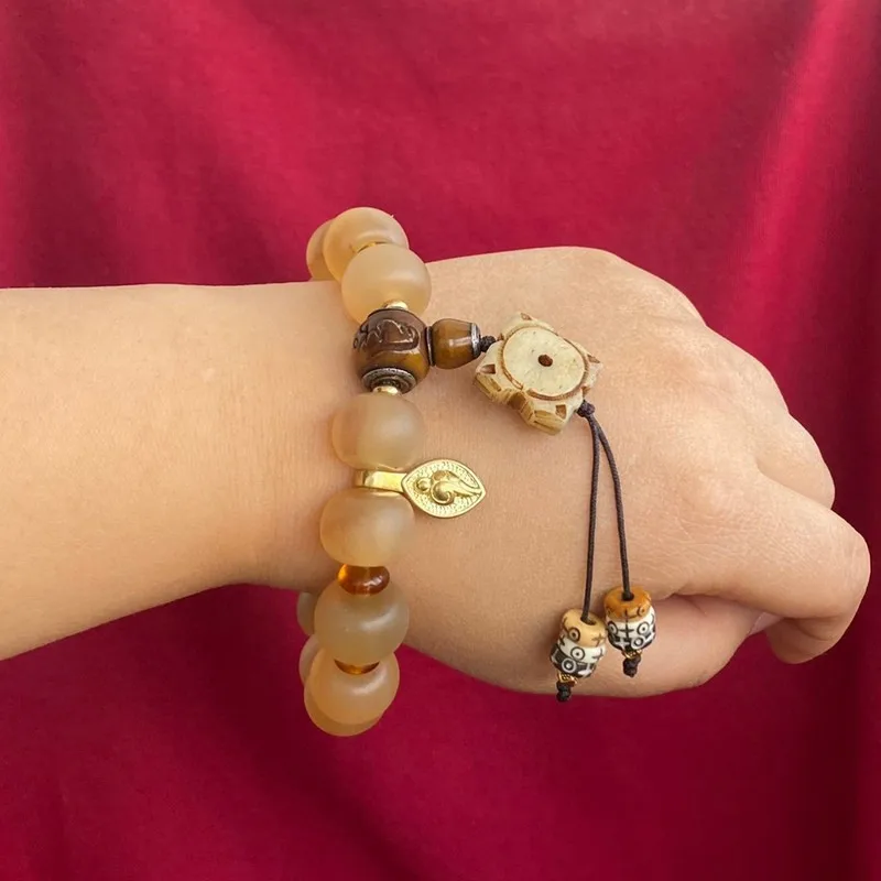 Oil-based, fully transparent unisex bracelet with Buddhist prayer beads made of sheep horn a collectible item