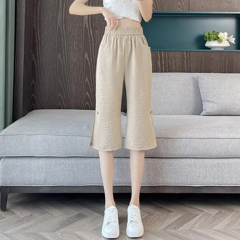 Moda Tasche impiombate elastiche Pantaloni svasati con bottoni Abbigliamento femminile 2025 Estate Nuovi pantaloni a vita alta vintage in tinta unita allentati