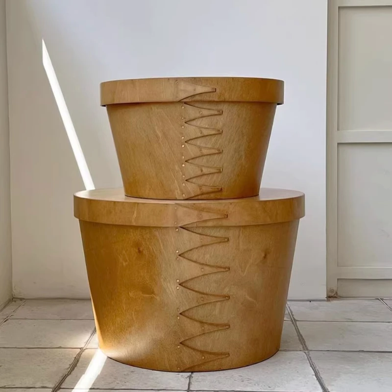 

A few bedside tables by the large wooden box.