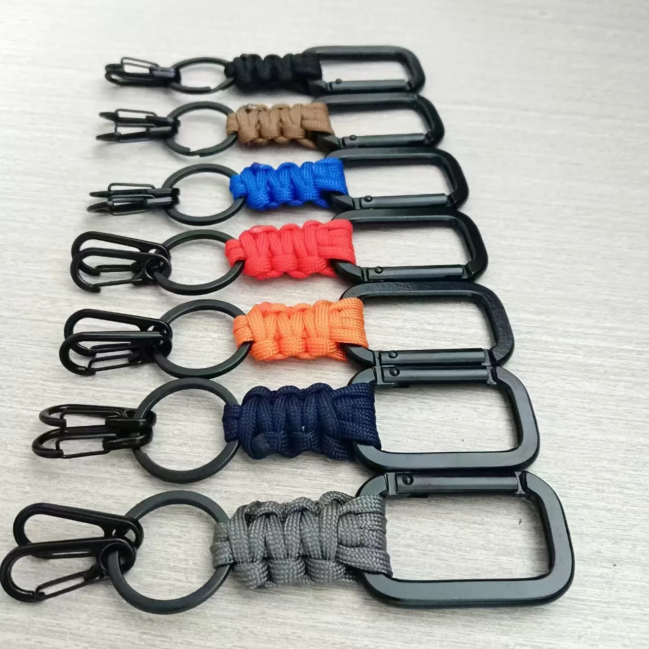 Outdoor hand-woven buckle Aluminum alloy flattened mountaineering buckle Multifunctional emergency keychain Backpack buckle
