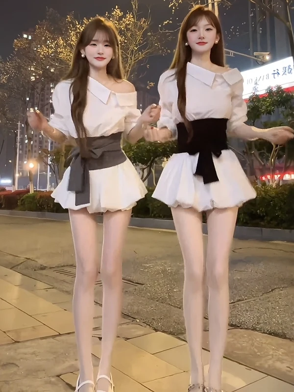 

Корейский стиль: комплект из двух предметов для женщин – рубашка с асимметричным вырезом на плече, длинными рукавами и завышенной талией, а также короткая юбка с цветочным принтом.