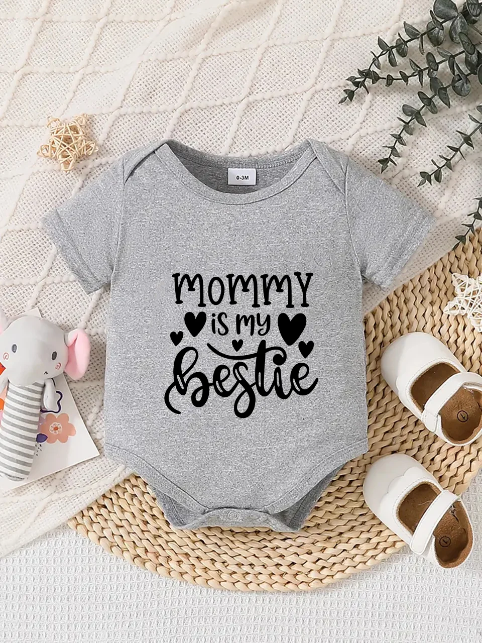 Playful letter-printed baby short-sleeve triangle bodysuit. Button closure for easy dressing, machine washable