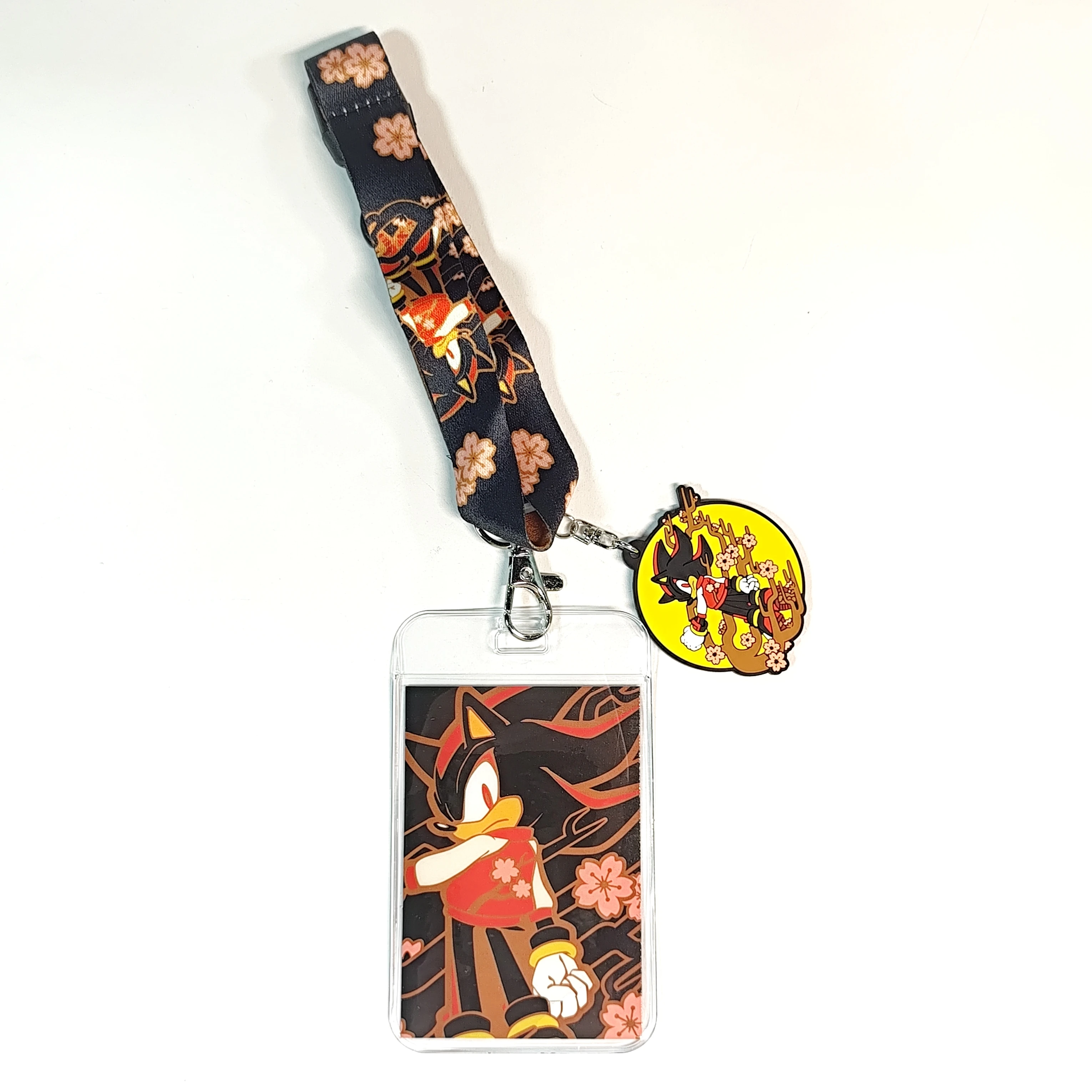 

Anime lanyard with cherry blossom patterns, a card holder, and a charm. Ideal for fans, stylish for daily use.