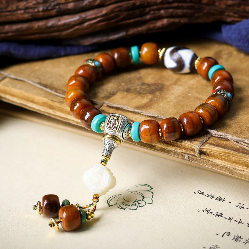 Tibetan-style yak tiger tooth dzi bracelet with Zaki Ram three-way bone bead and cloud pendant