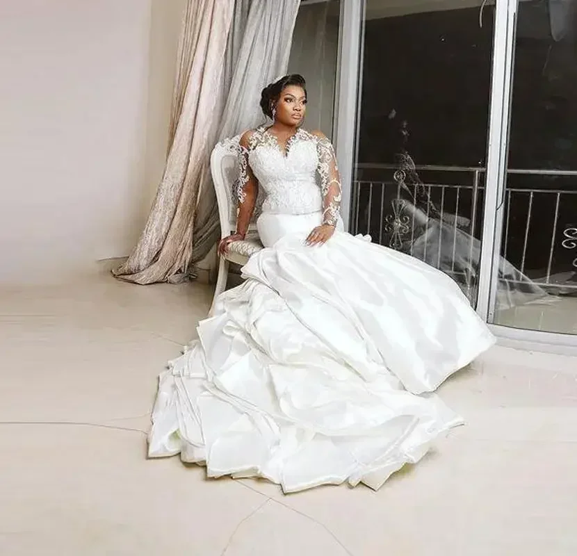

Customized Plus Size Mermaid Wedding Dresses Lace Beaded Long Sleeves Arabic Bridal Sheer Neck Ruffles Satin Vestido De Noiva