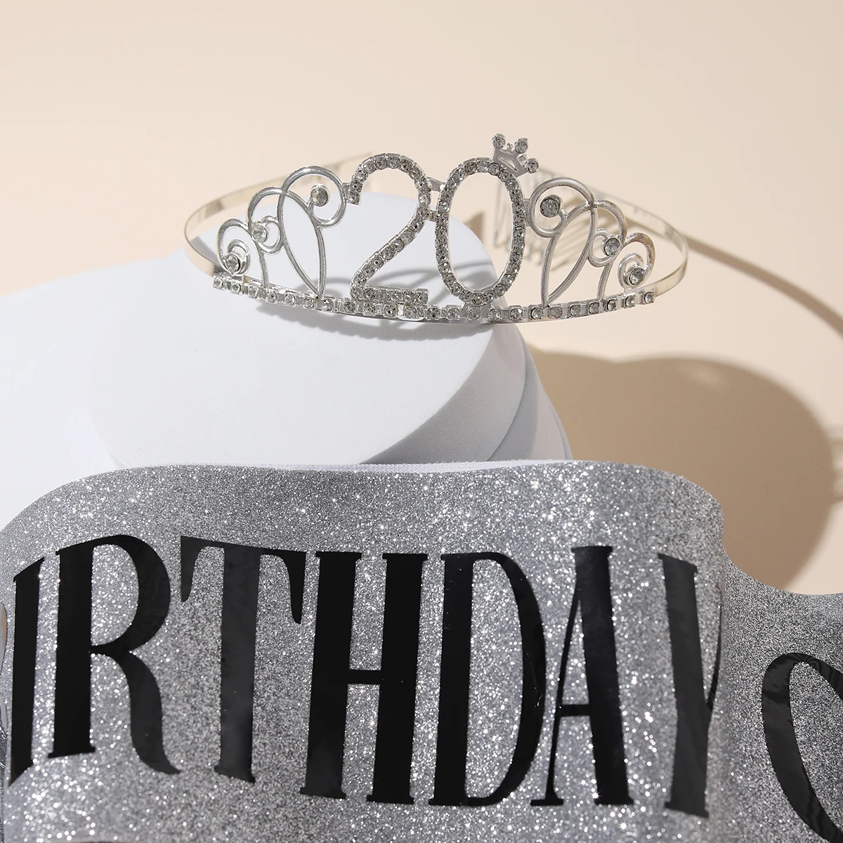 A classic 20 years old birthday themed digital crown paired with ribbons suitable for birthday event accessories