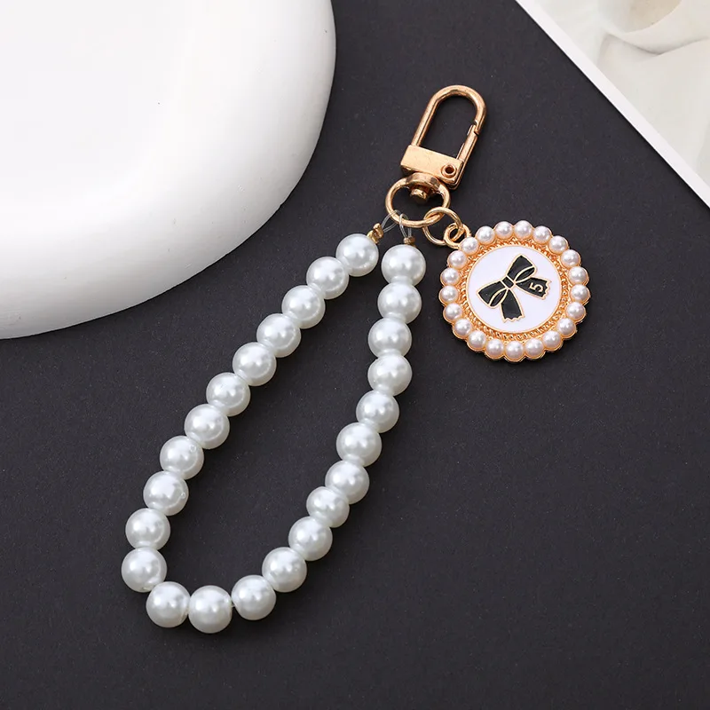 New DIY mobile phone case jewelry bow pearl pendant love pendant earphone cover bag hanging chain