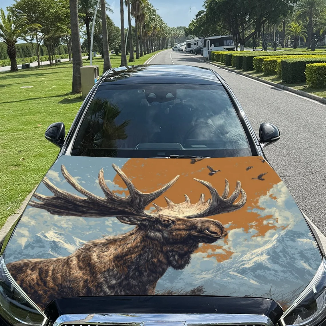 

A majestic moose with large antlers stands against a mountainous backdrop, painted on a car hood. Perfect for nature lovers!Hood