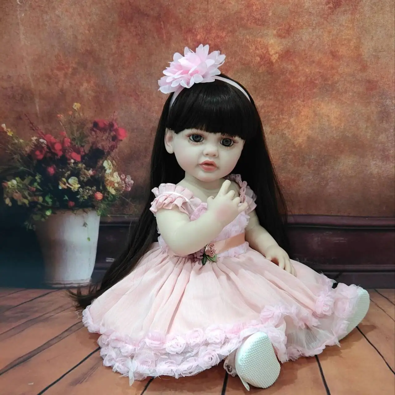 Lifelike 22 - Inch Reborn Baby Doll in Adorable Pink Outfit with Floral Decoration - Perfect for Gifting and Snuggling