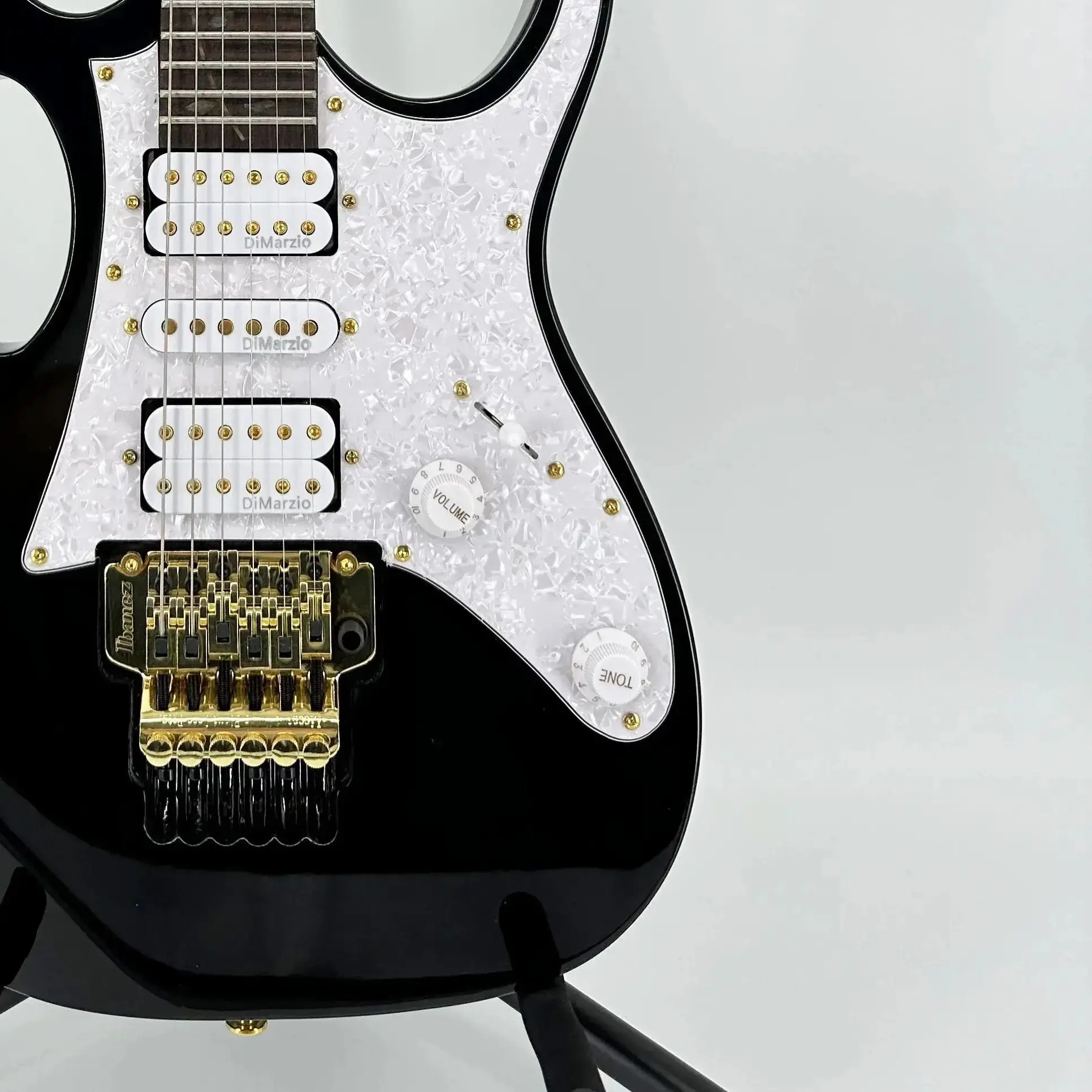 

Black mahogany electric guitar with rosewood neck and white pickguard, featuring H-S-H pickups