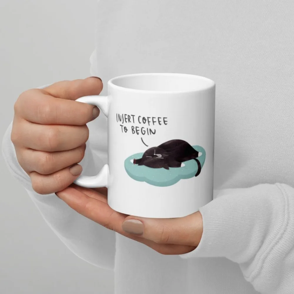 This reusable, machine washable mug features a black cat design that makes it perfect for cat owners.