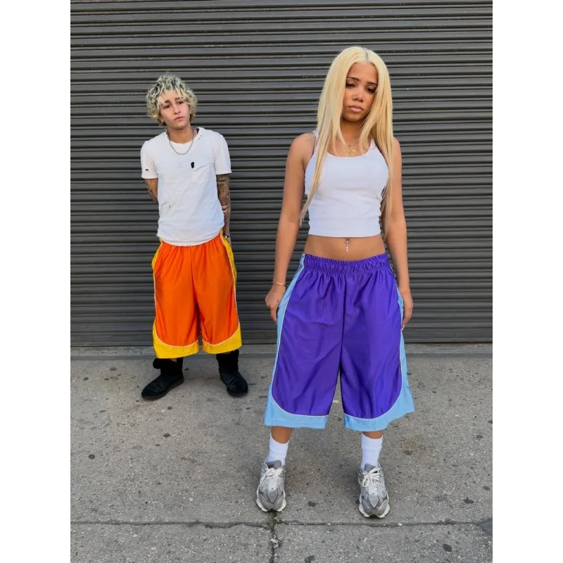 Retro contrasting bright seven inch mid length pants with drawstring and elastic waistband, wide legs, loose fit sports shorts
