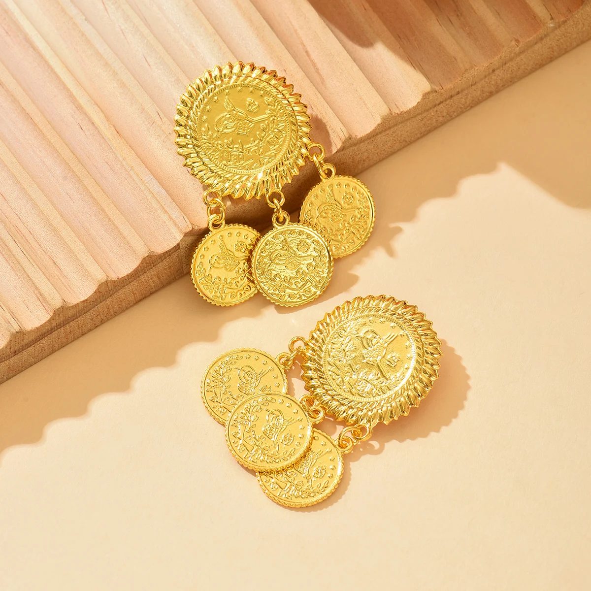 A pair of retro ethnic-style circular coin-pattern pendant design brooches as accessories for the bridal wedding dress a corsage