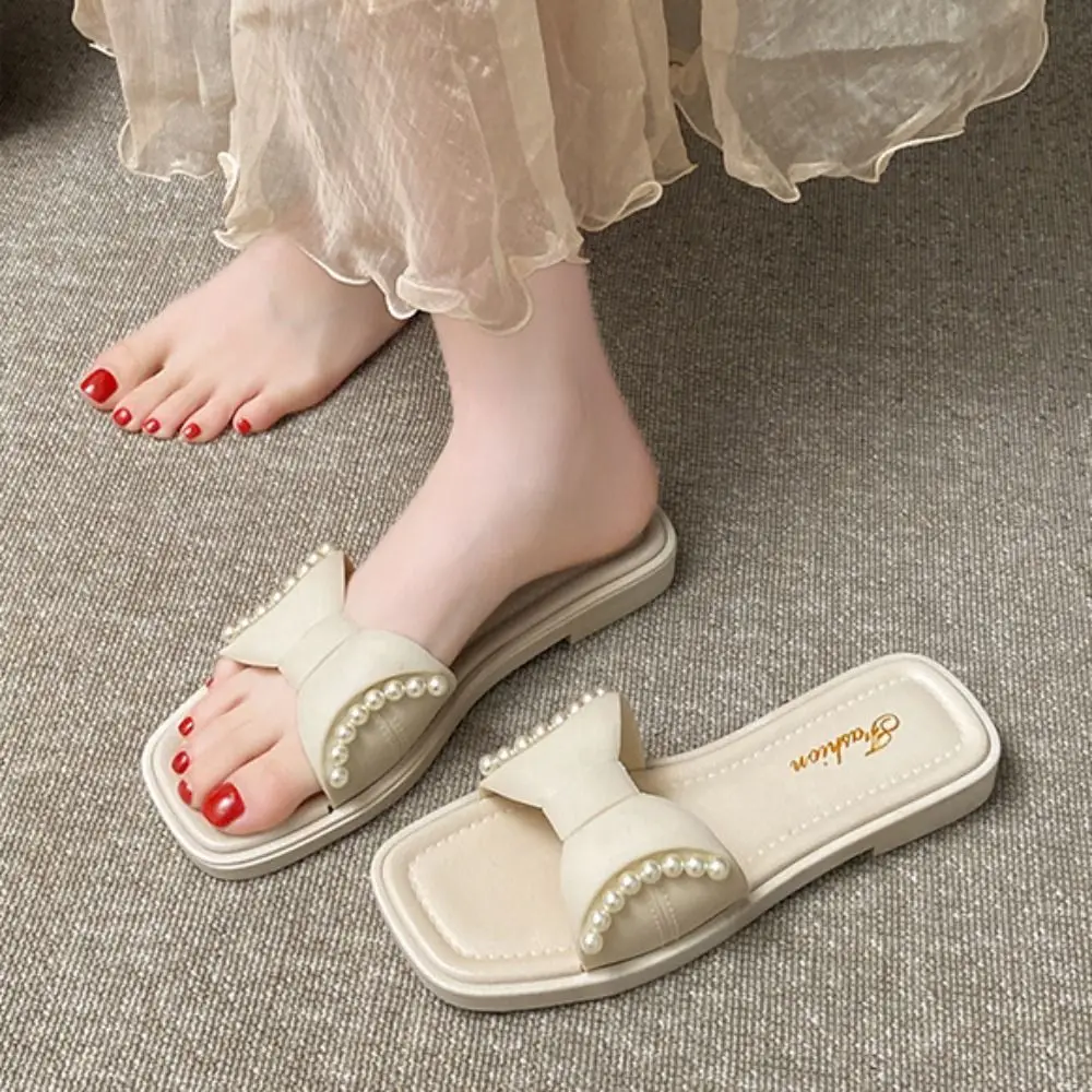 Zapatillas planas con lazo de suela suave a la moda, sandalias deslizantes con perlas dulces de PVC, zapatillas antideslizantes de tacón bajo, ropa de playa para mujer