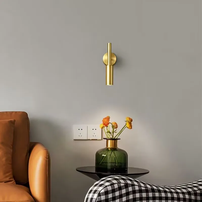 The background wall of the living room features wall mounted picture lights, ceiling lights, rotatable small spotlights