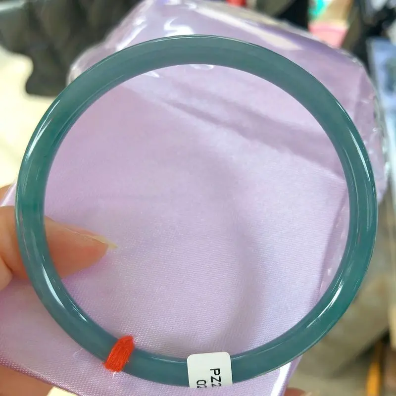 Jadeite A-grade, fine round bangle with a jingling ring featuring a creamy icy texture and a blue-tinged water-like luster