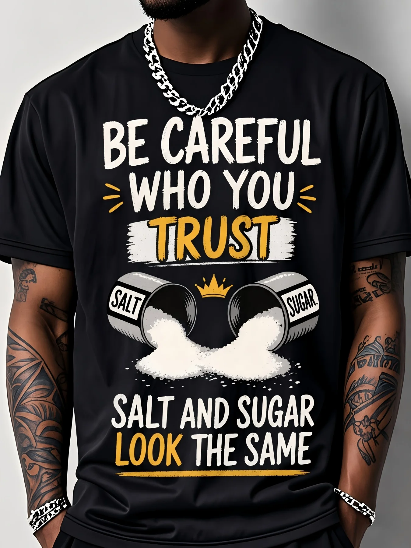 Men's Black Short-Sleeved T-Shirt, Featuring Bold 'BE CAREFUL WHO YOU TRUST' Graphic, Unique Design with Overturned Salt And Sugar Shakers, Perfect for Streetwear Lovers, Embodies Cautionary Message About Trust And Appearances, Comfortable Fit for