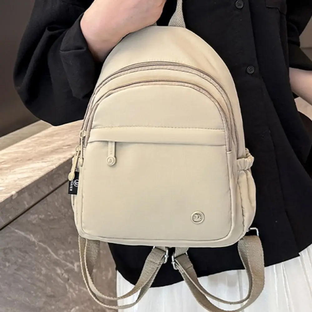 Zaino portatile da donna in nylon leggero con manico multitasche zaino casual impermeabile tinta unita