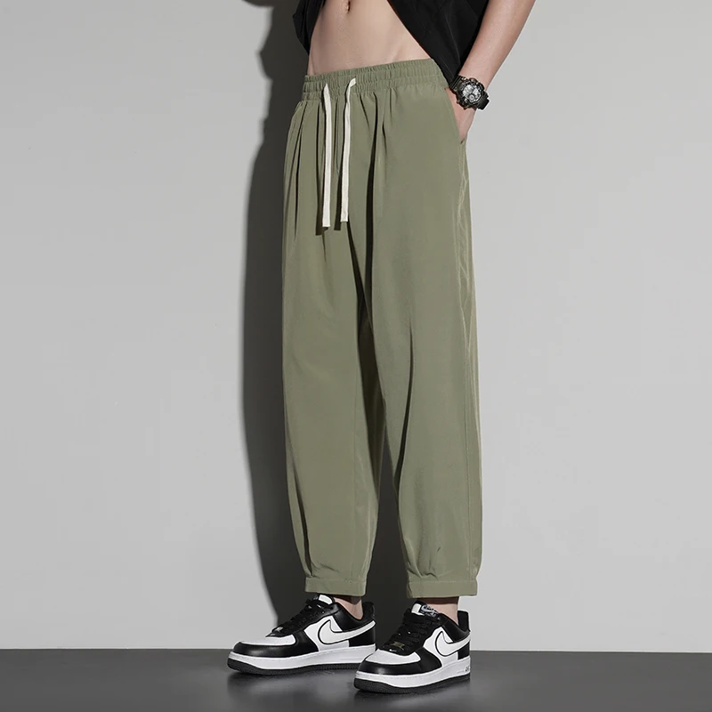 New trend summer men's solid color pocket drawstring elastic casual ice silk leggings loose wide leg cropped sports pants