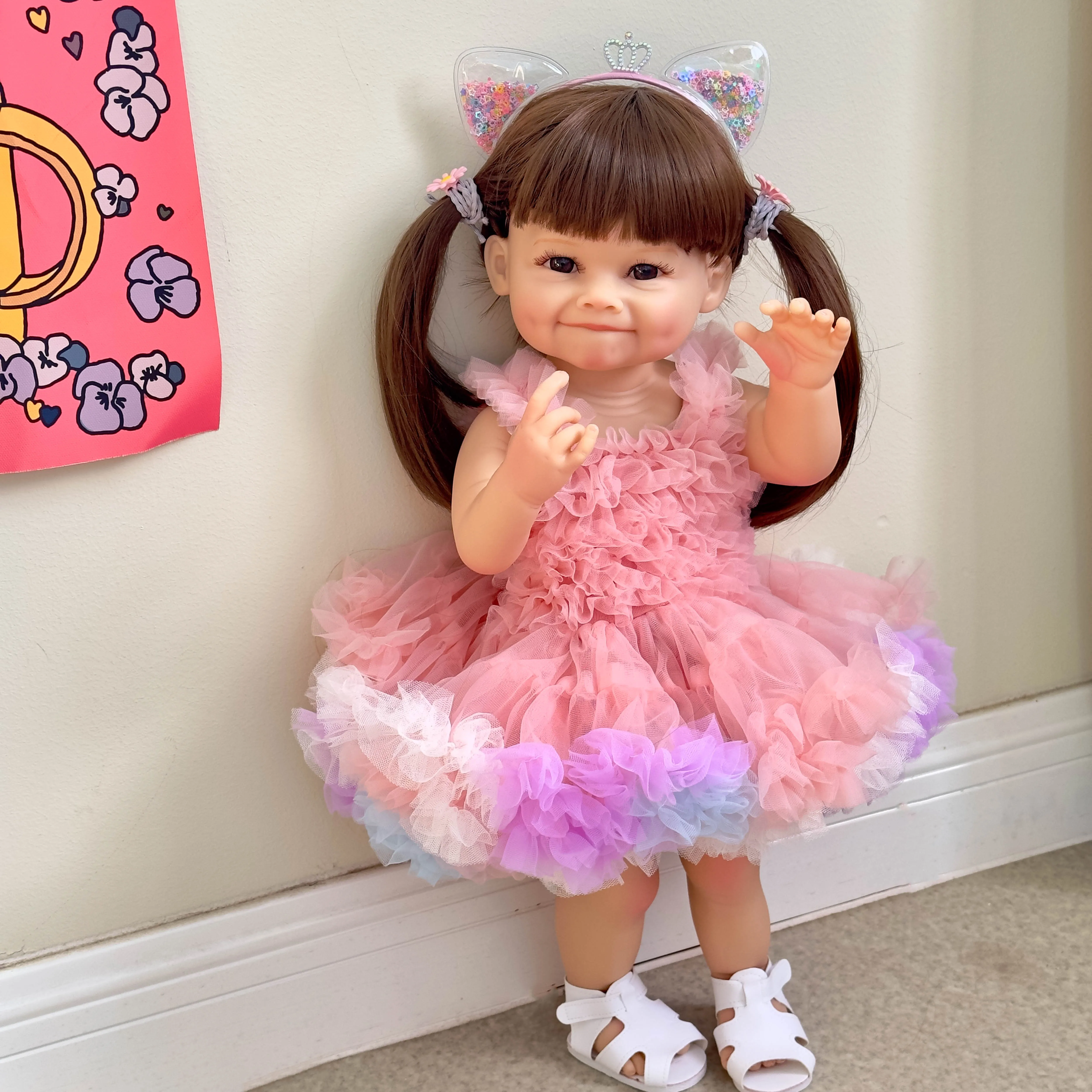 55cm full glue immersible simulation doll standing against a wall, new smiling dimpled baby