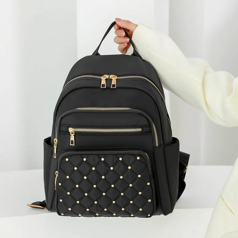 Solid-color diamond-shaped sewn riveted women's backpack, lightweight nylon fabric, large-capacity multi-pocket travel bag
