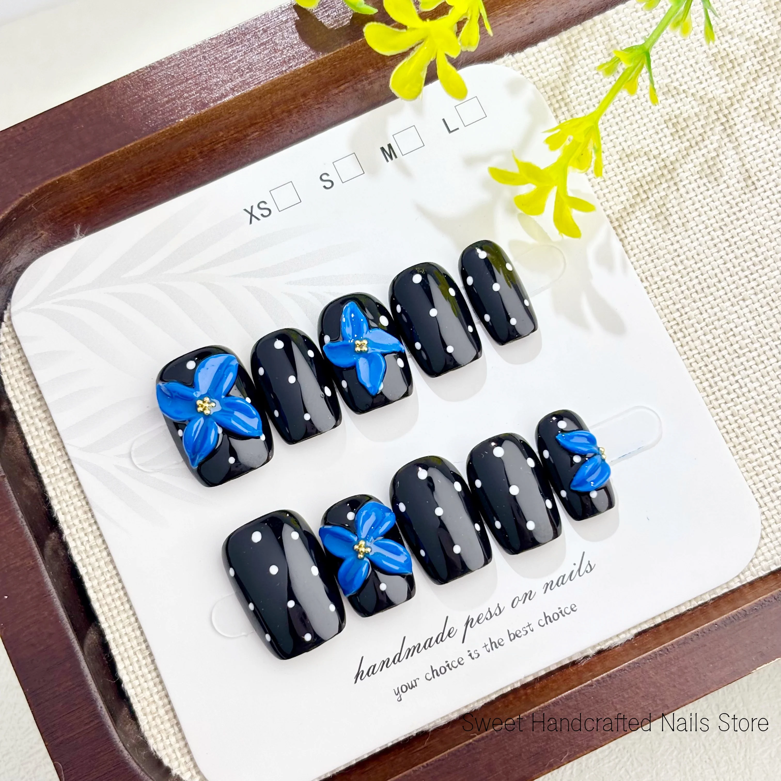High-end handmade short square press-on nails, deep black with white polka dots, featuring 3D blue carvings and gold beads, reusable and perfect for everyday wear or Halloween nail gift, comes with a nail tool kit