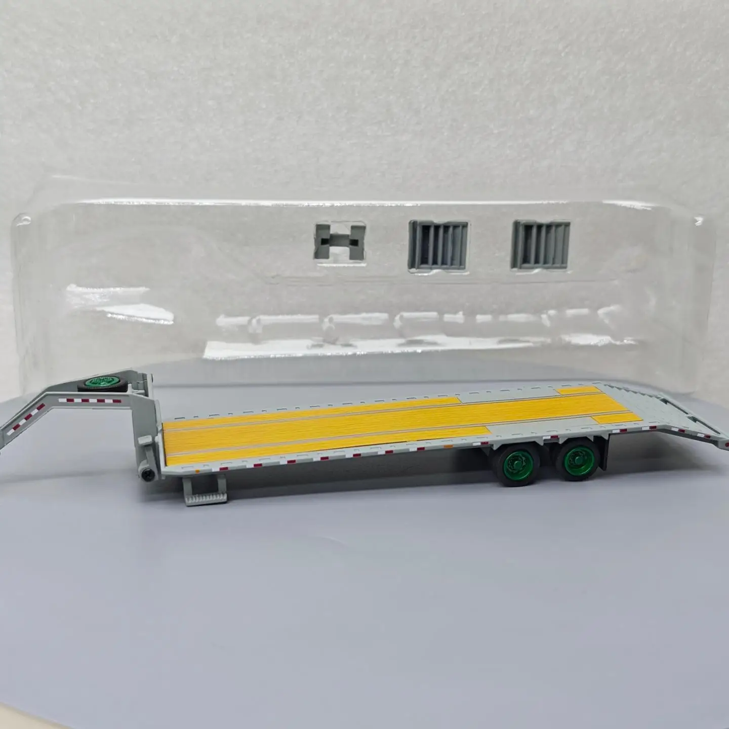 

GreenLight 1:64 Gooseneck Trailer - Primed Grey with Red and White Eye-catching Stripes Green Machine Diecast Model Collectible