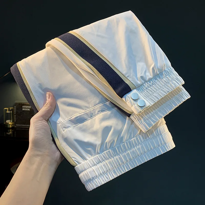 White ultra-thin ice silk pants for men in the summer of 2025, new loose leg binding trend, woven belt splicing casual pants
