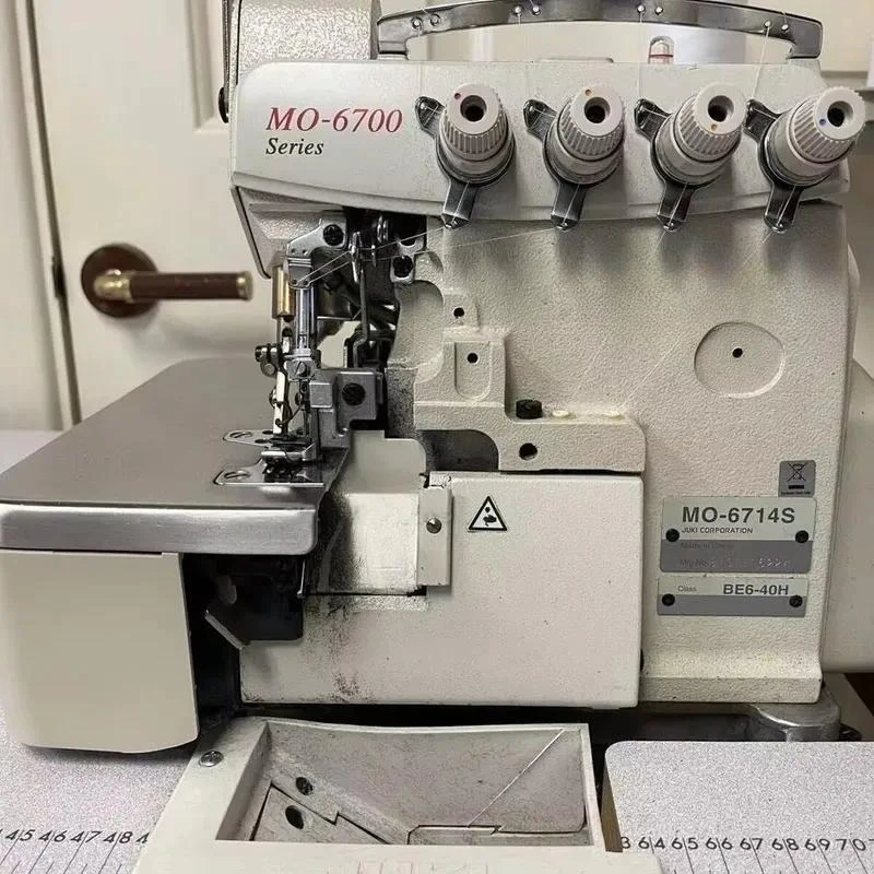 Used High Speed Jukis 6714S Four 4 Thread Industrial Overlock Sewing Machine with Motor 5500 Sti/min 5-10mm Thickness