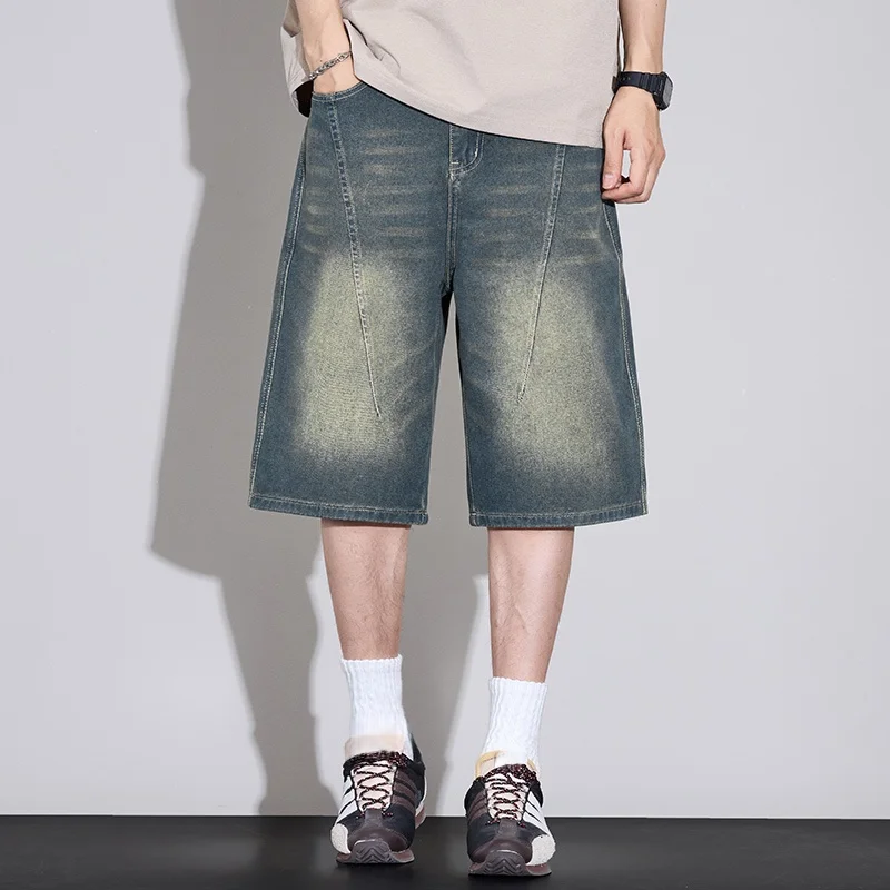 American-style men's vintage distressed denim shorts a summer trend are loose fitting wide legged and versatile mid length pants