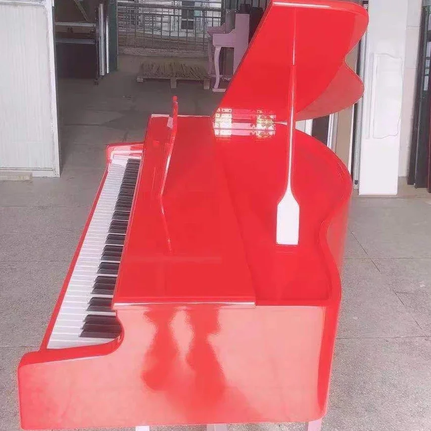 baby red grand piano with piano bench red