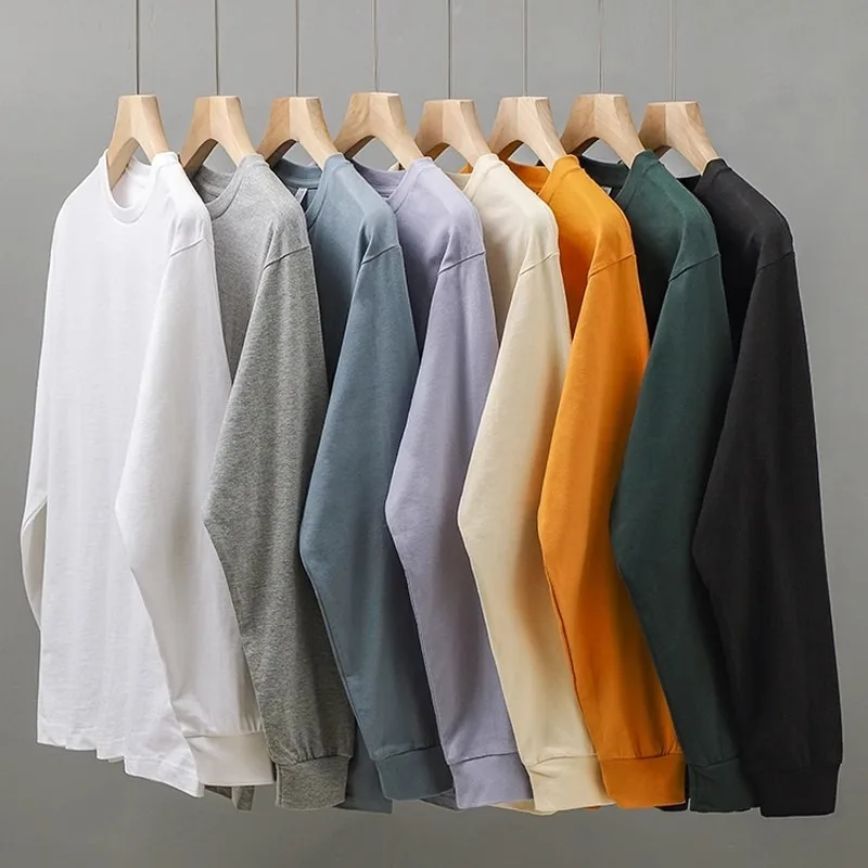 قميص أبيض بأكمام طويلة من القطن الخالص ثقيل الوزن برقبة مستديرة قميص أساسي للارتداء الداخلي بأسلوب عادي مريح يناسب جميع المواسم