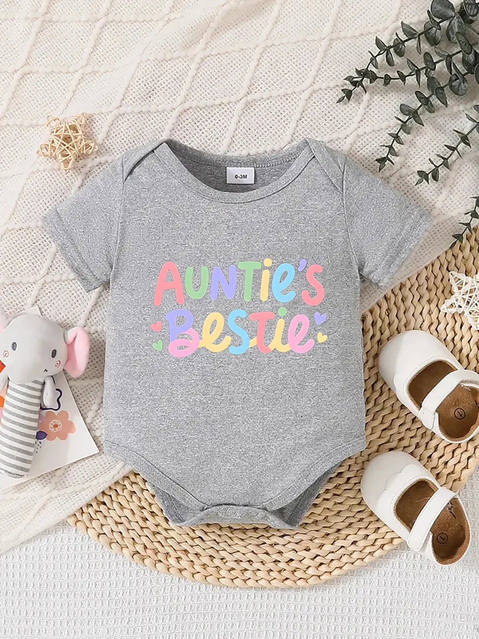 Playful letter-printed baby short-sleeve triangle bodysuit. Button closure for easy dressing