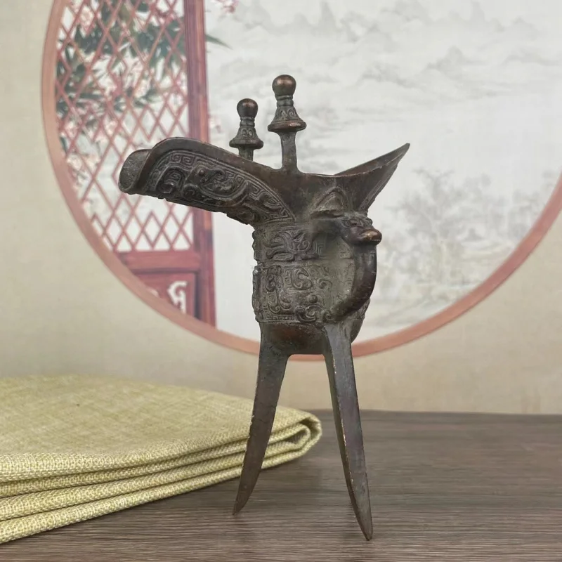 Bronze three-legged , Fu Xin's wine cup, office desk ornament, home decoration, Xuan Niao beast face pattern
