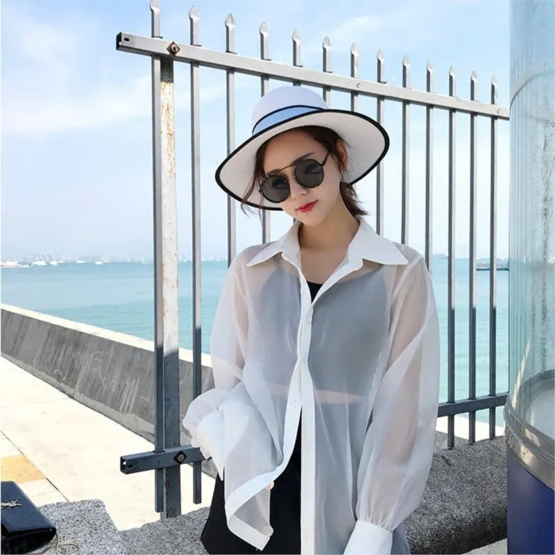 Lady in a hat white top with wide brim for vacation by the seaside