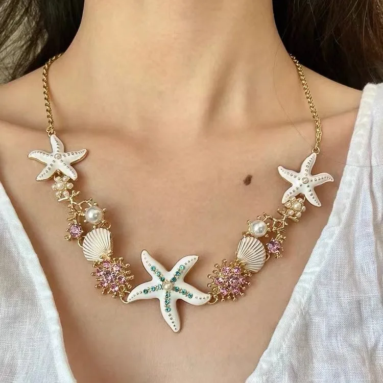 Starfish-shaped pendant necklace in vibrant blue hue featuring geometric design and electroplated alloy construction on durable