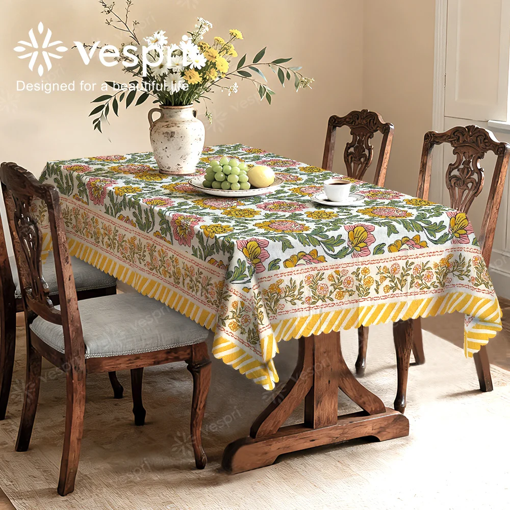 Vespri Spring Tablecloth, with white and yellow decorations, featuring flowers and green leaves