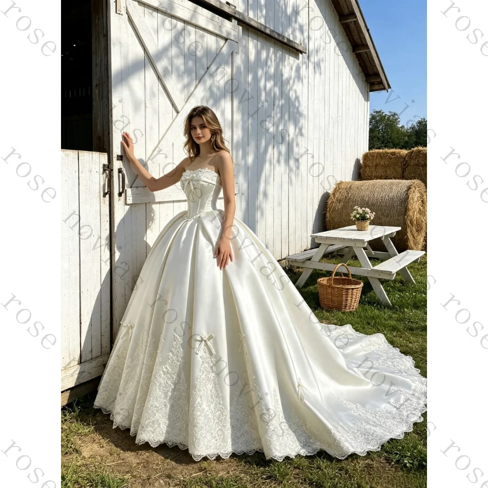 Customized Luxury Satin Strapless Ball Gown 2026 Lace Hem Floral Bow Details Fluffy Princess Bridal Gown Suitable for Parties