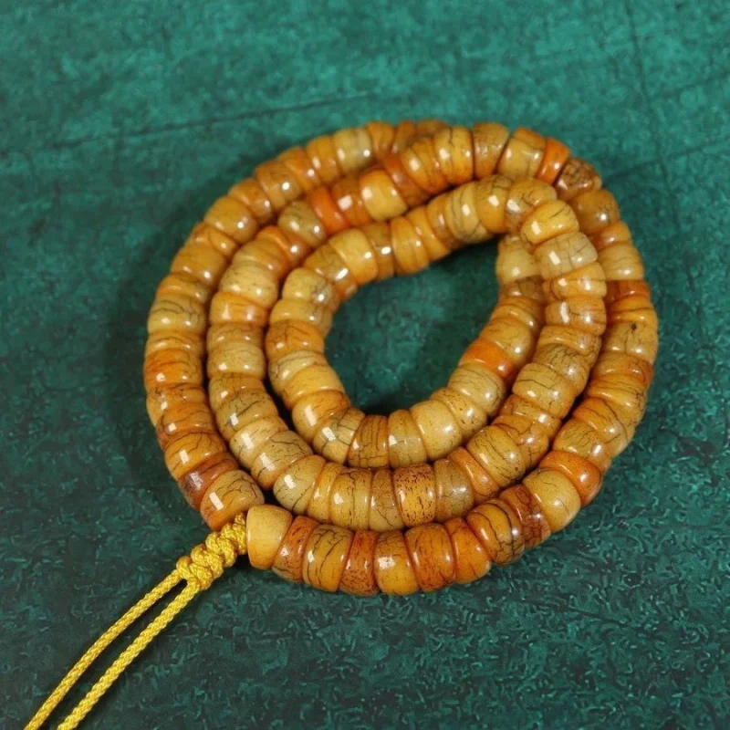 Yak bone with patina and fissures, 108 beads in the shape of a horseshoe, long string of old ox bones
