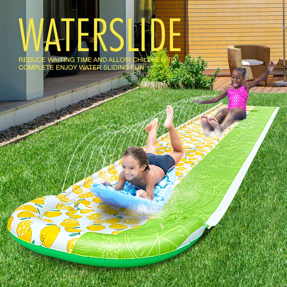 Children play with water on the riverside lawn in summer. Cloth slide. Children play with water. Water spray pad. Water slide