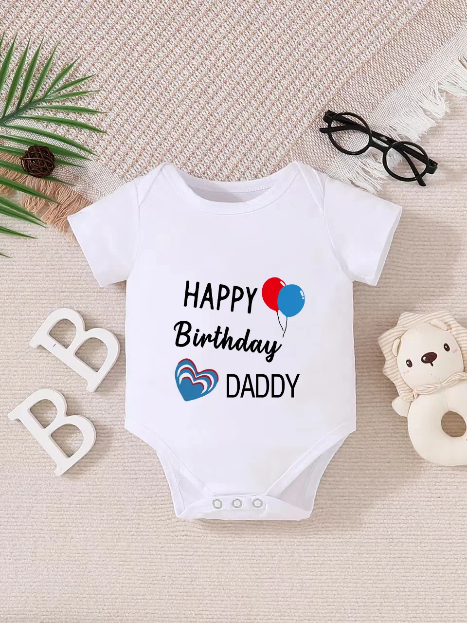 Playful letter-printed baby short-sleeve triangle bodysuit. Button closure for easy dressing