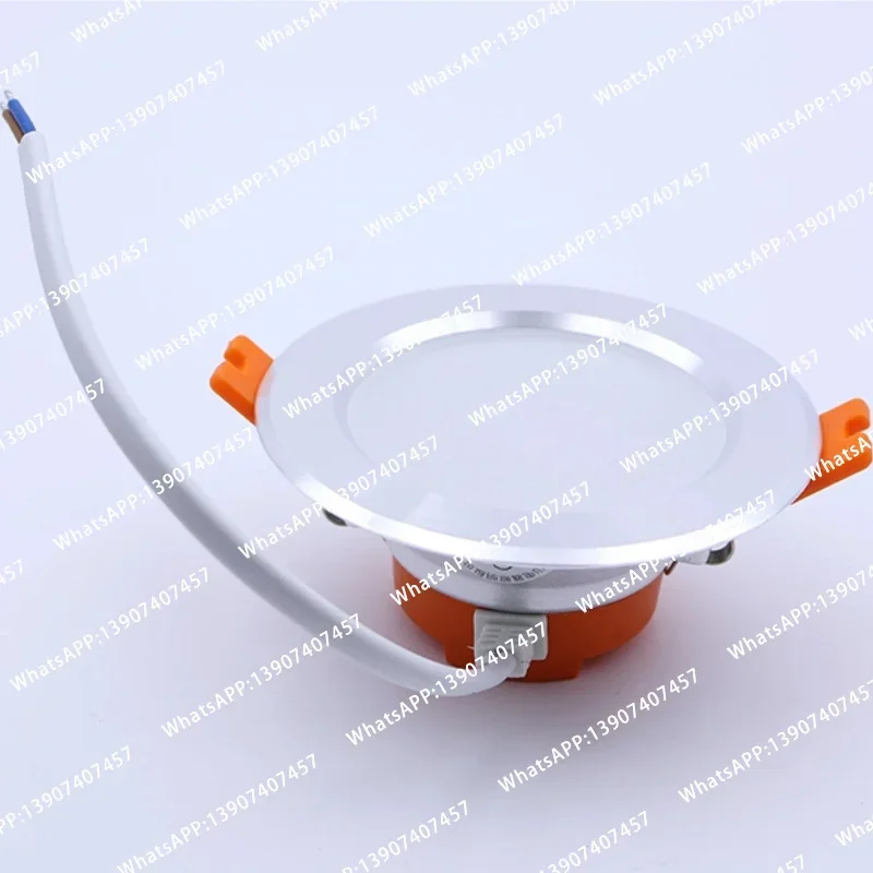 Integrated LED downlights are embedded in the ceiling of elevator cars
