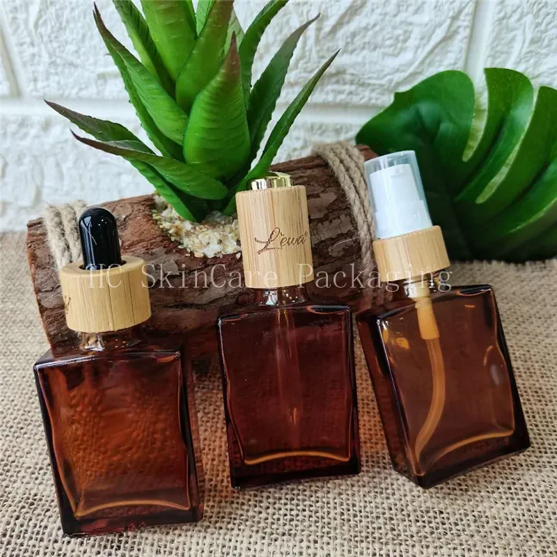 

Wholesale high quality Empty Amber Dropper Glass Hair Oil Bottles square flat glass cosmetic bottle with dropper and bamboocap